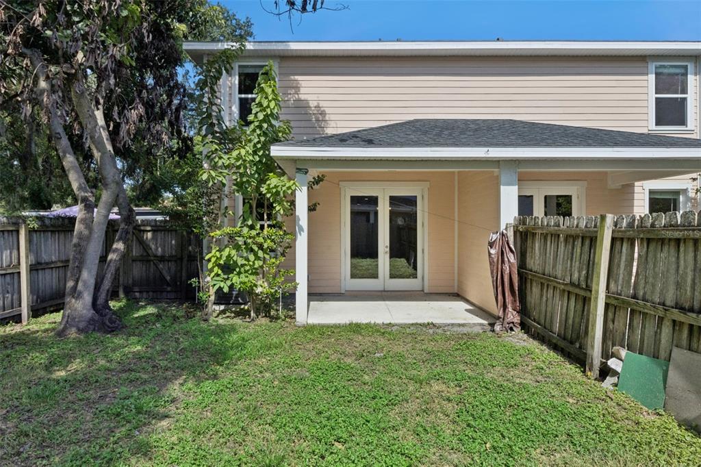 A kitchen with dark cabinets and a breakfast bar overlooks an open-concept living area — 2544 MAYER STREET, ORLANDO, FL