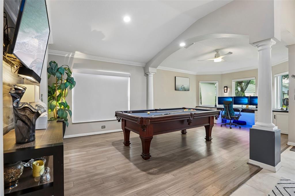 A game room features a pool table, wood-look flooring, and a computer desk area — 19009 FALCONS PLACE, TAMPA, FL