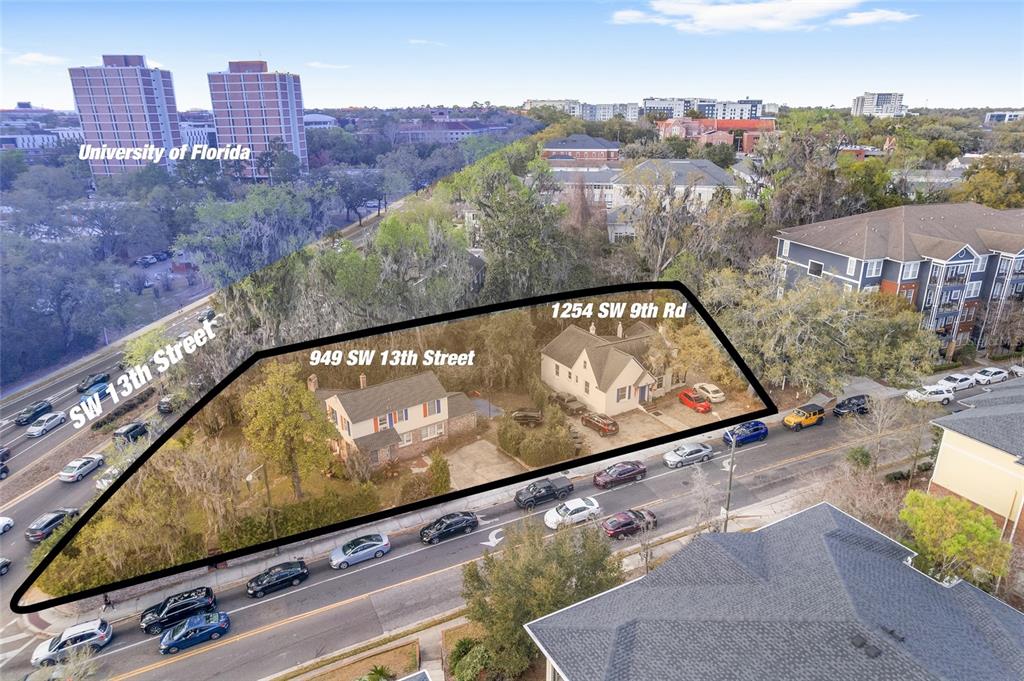 An aerial view shows two houses on a corner lot near a busy street — 949 SW 13TH STREET, GAINESVILLE, FL