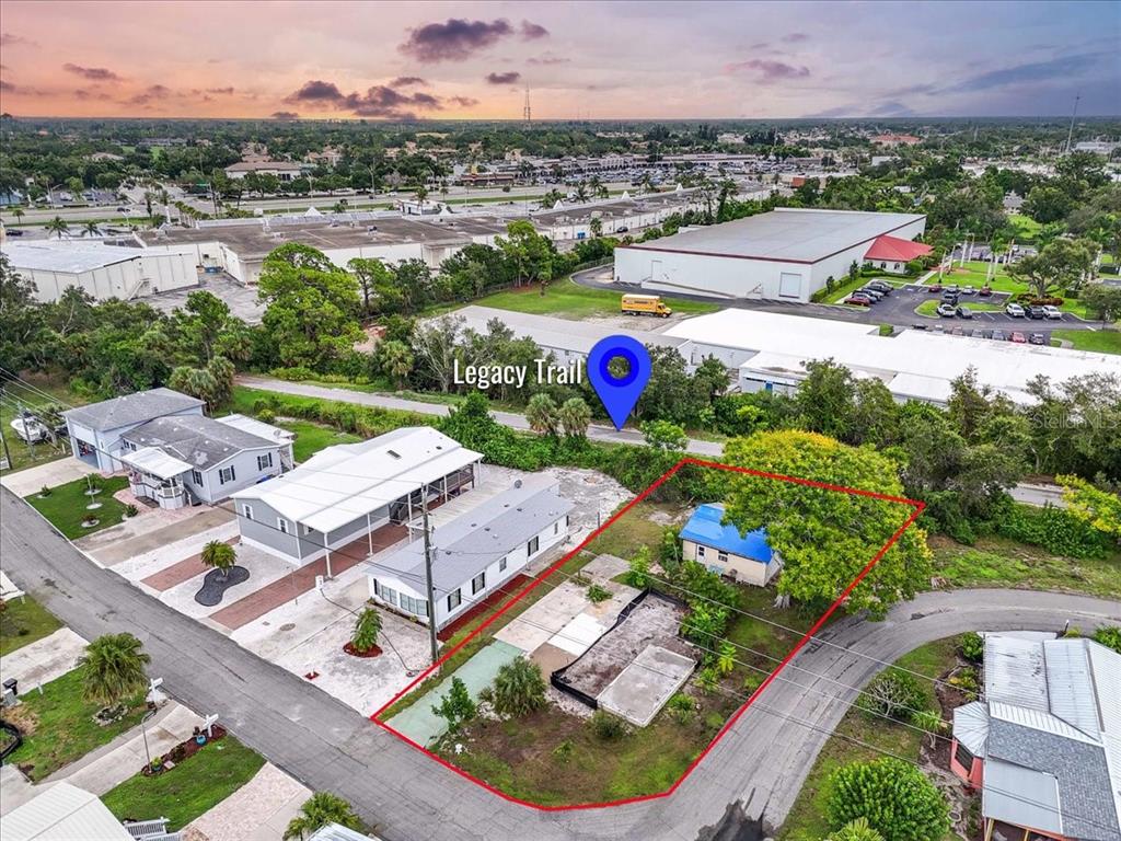 An aerial view shows a residential lot outlined in red next to the Legacy Trail — 30 HATCHETT CREEK ROAD, VENICE, FL