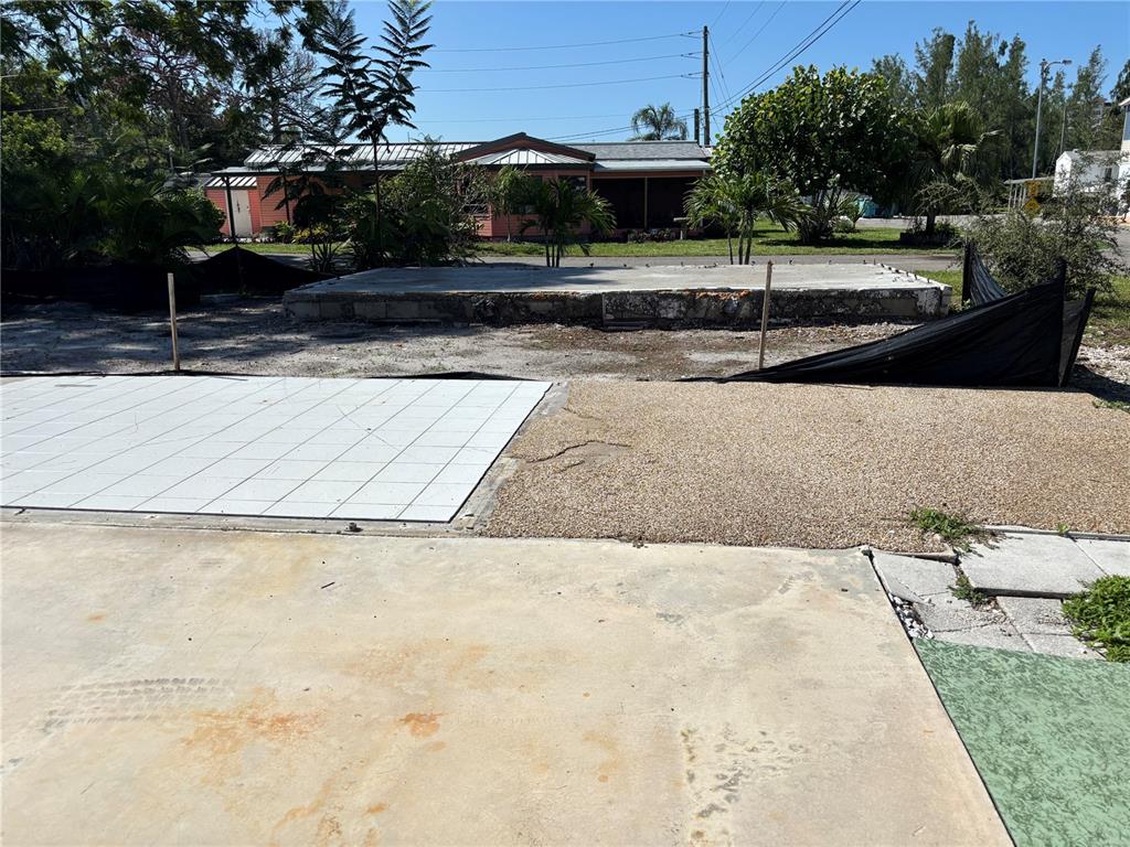 A concrete slab foundation sits in a yard with paved and gravel patio areas — 30 HATCHETT CREEK ROAD, VENICE, FL