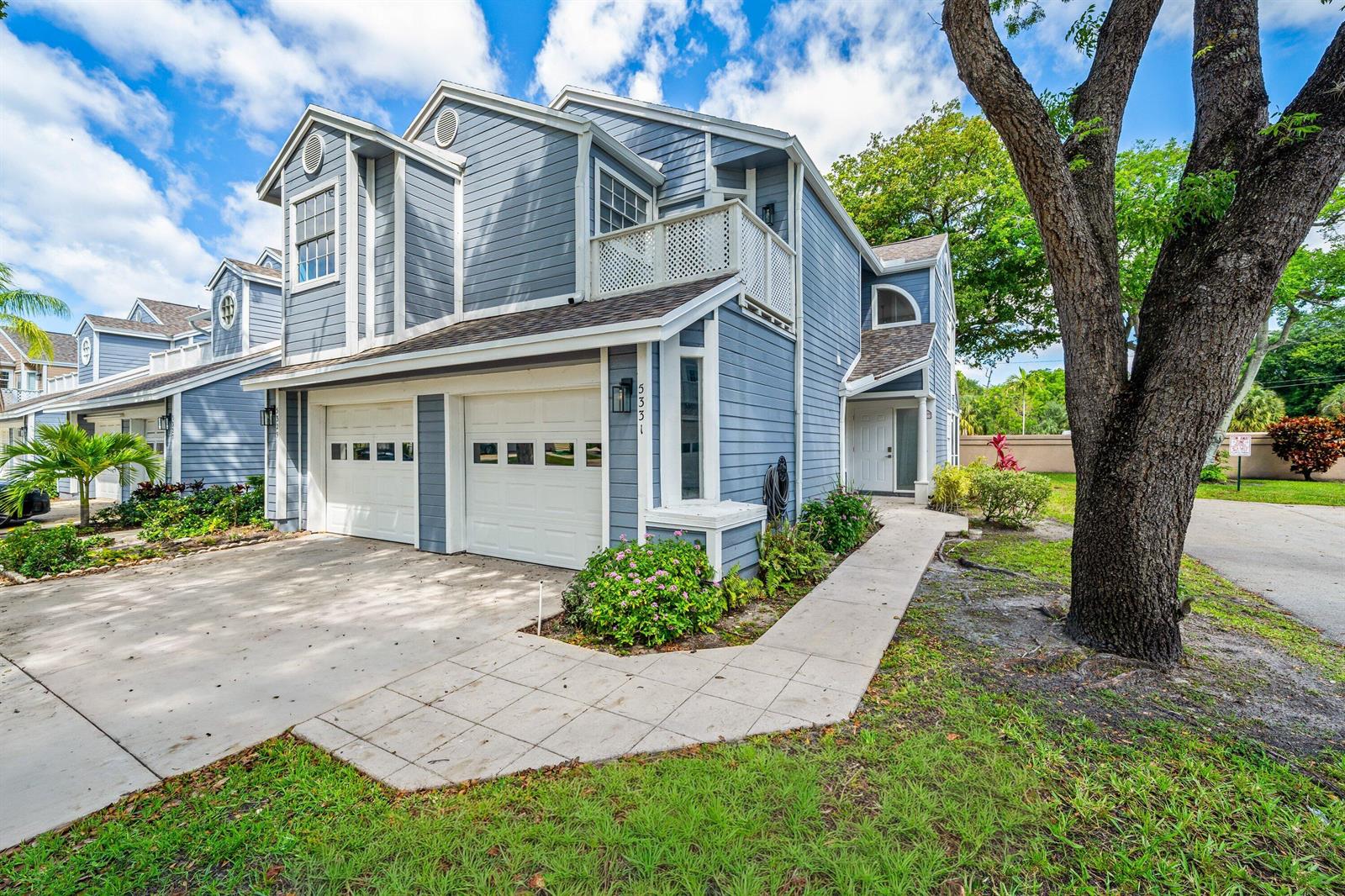 A two-story blue house with a two-car garage, a balcony, and a concrete walkway — 5331 Buckhead Circle # 1030, Boca Raton FL 33486, BOCA RATON, FL