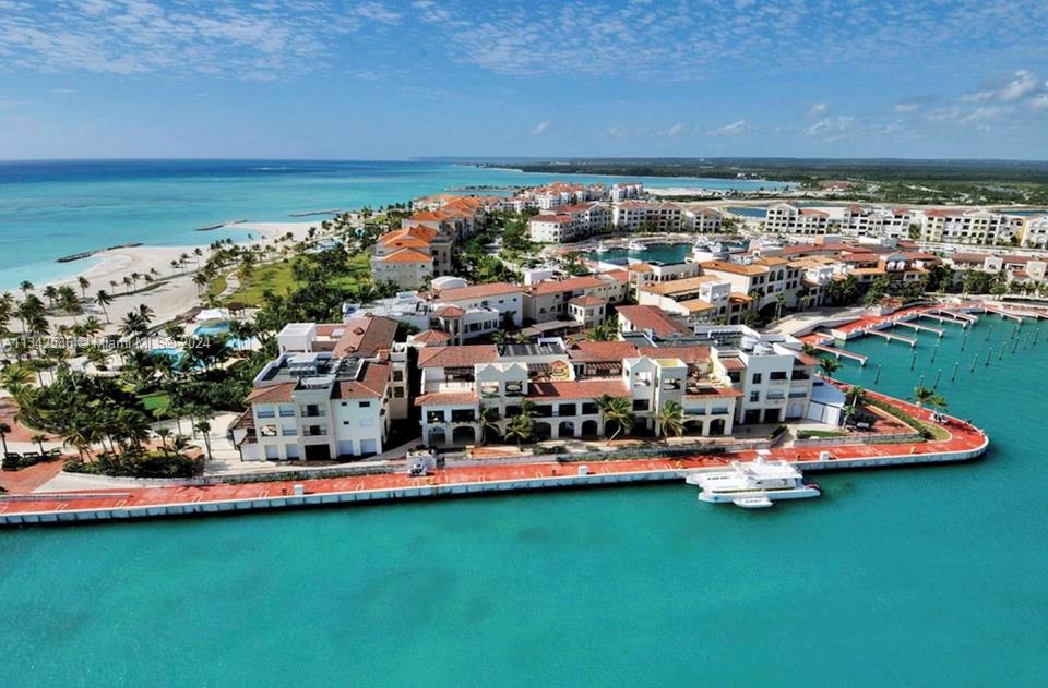 An aerial view of a coastal resort complex featuring white buildings, a marina, and beaches — . Condominio Fundadores Marina Cap Cana, FL, FL