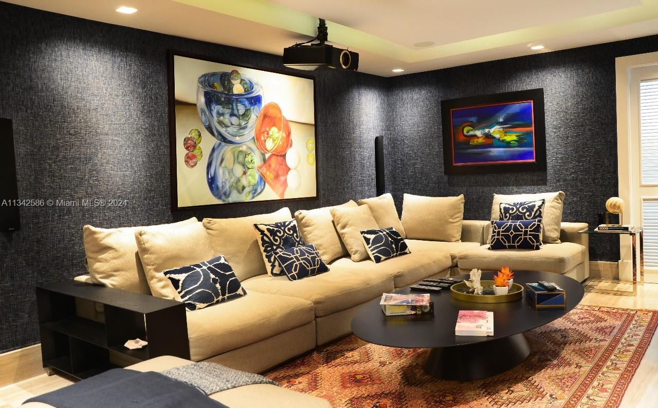 A media room features a large sectional sofa, a projector, and dark textured wallpaper — . Condominio Fundadores Marina Cap Cana, FL, FL