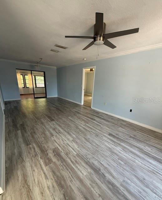 A living room with light blue walls, a ceiling fan, and wood-look flooring — 465 E SEMINOLE DRIVE, VENICE, FL