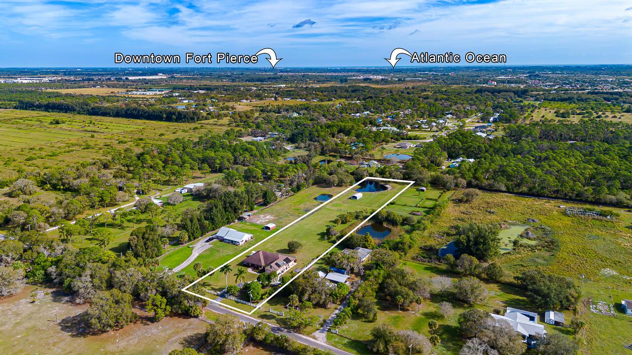 An aerial view shows a house with a pool on a large, fenced rural lot — 2774 Gentile Road, Fort Pierce FL 34945, FORT PIERCE, FL