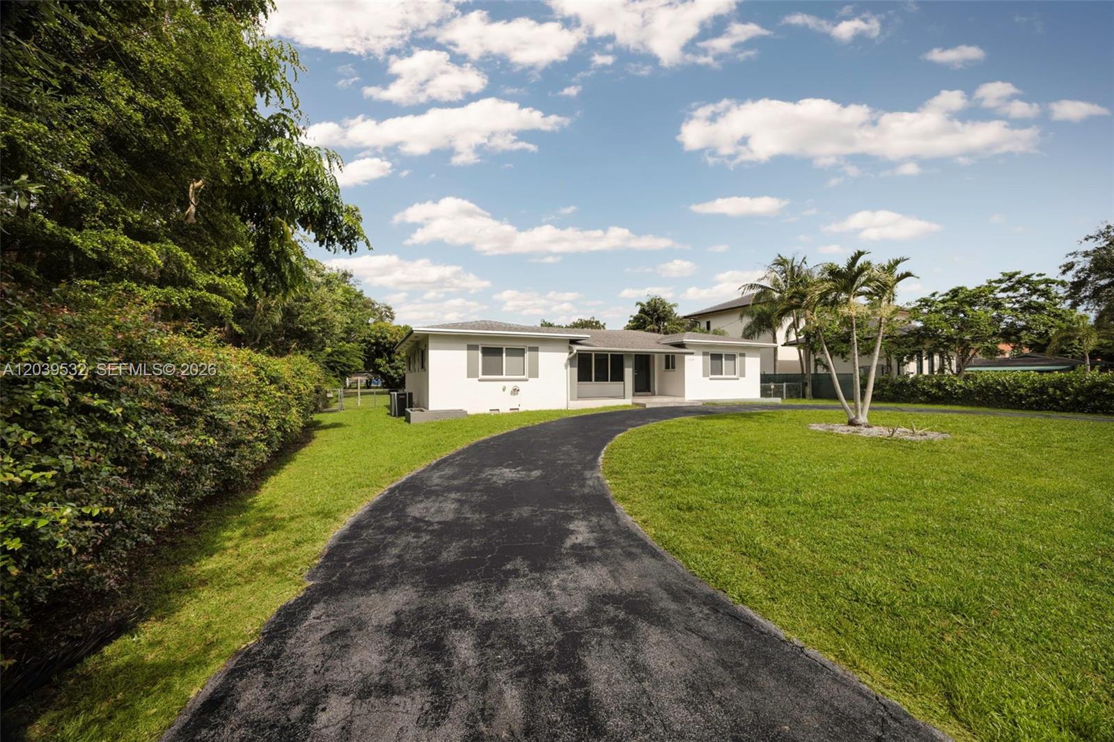 A single-story white house with a curved asphalt driveway and a large green lawn — 7840 SW 71st Ave, Miami FL 33143, MIAMI, FL