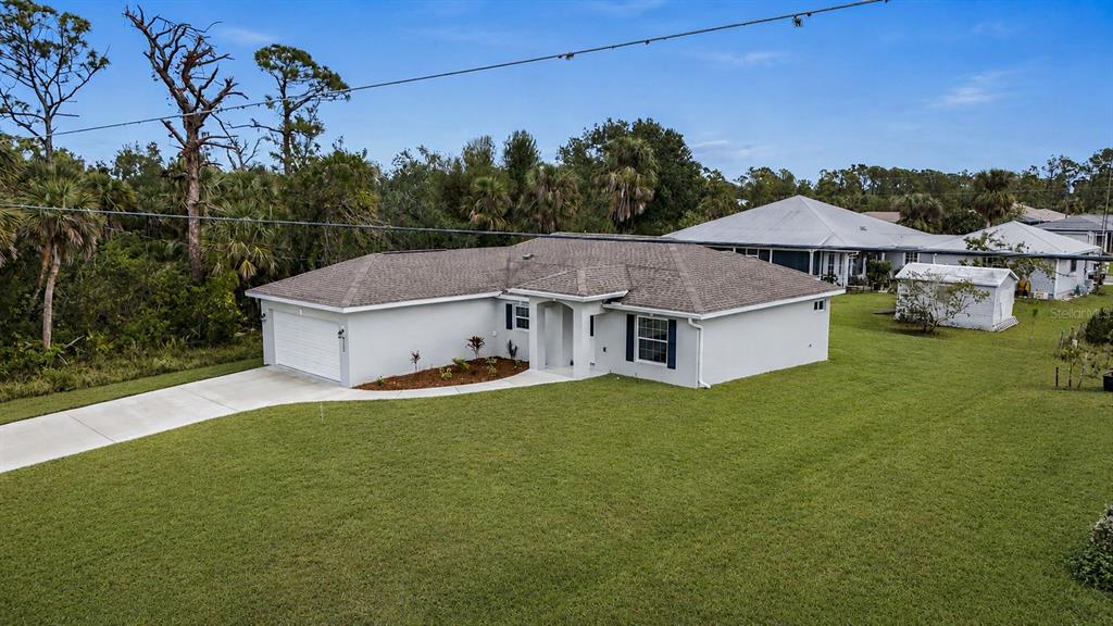 An aerial view of a single-story house with a white exterior and a gray roof — 5400 JENNINGS BOULEVARD, PORT CHARLOTTE, FL