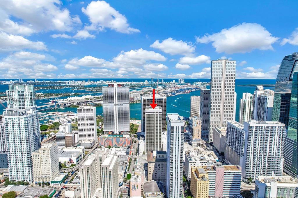 An aerial view of a dense city skyline featuring numerous high-rise buildings near the water — 1 SE 3rd Ave, Miami FL 33131, MIAMI, FL