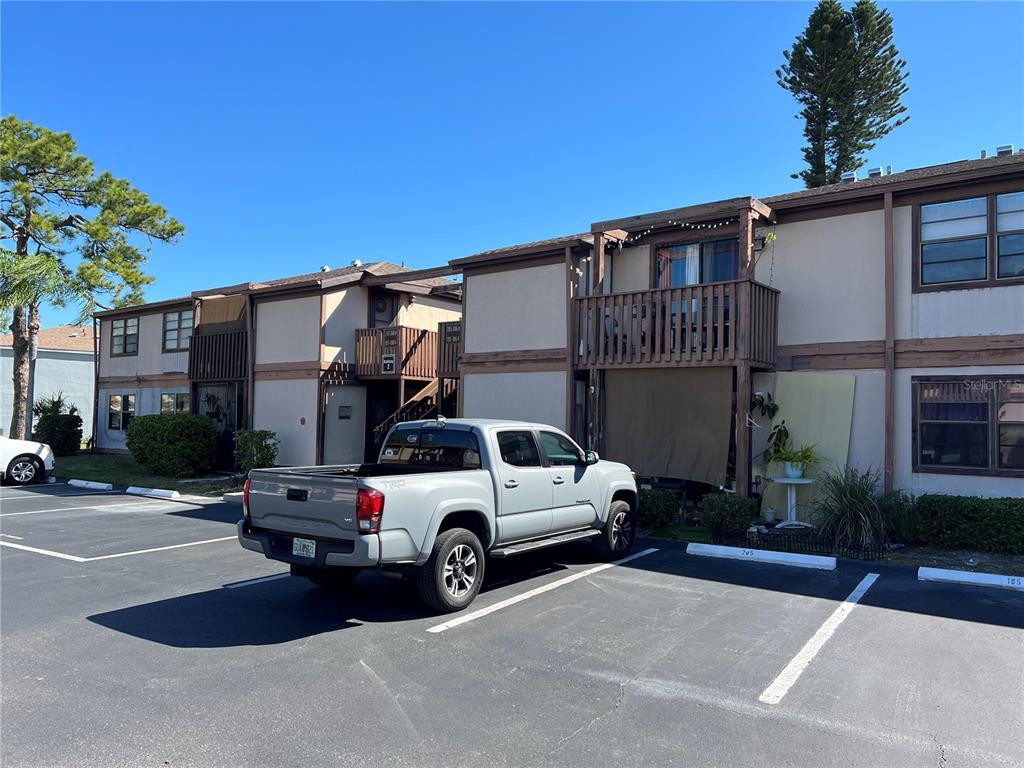 A gray pickup truck is parked in front of a two-story apartment building — 5026 WATER OAK DRIVE UNIT 208, BRADENTON, FL