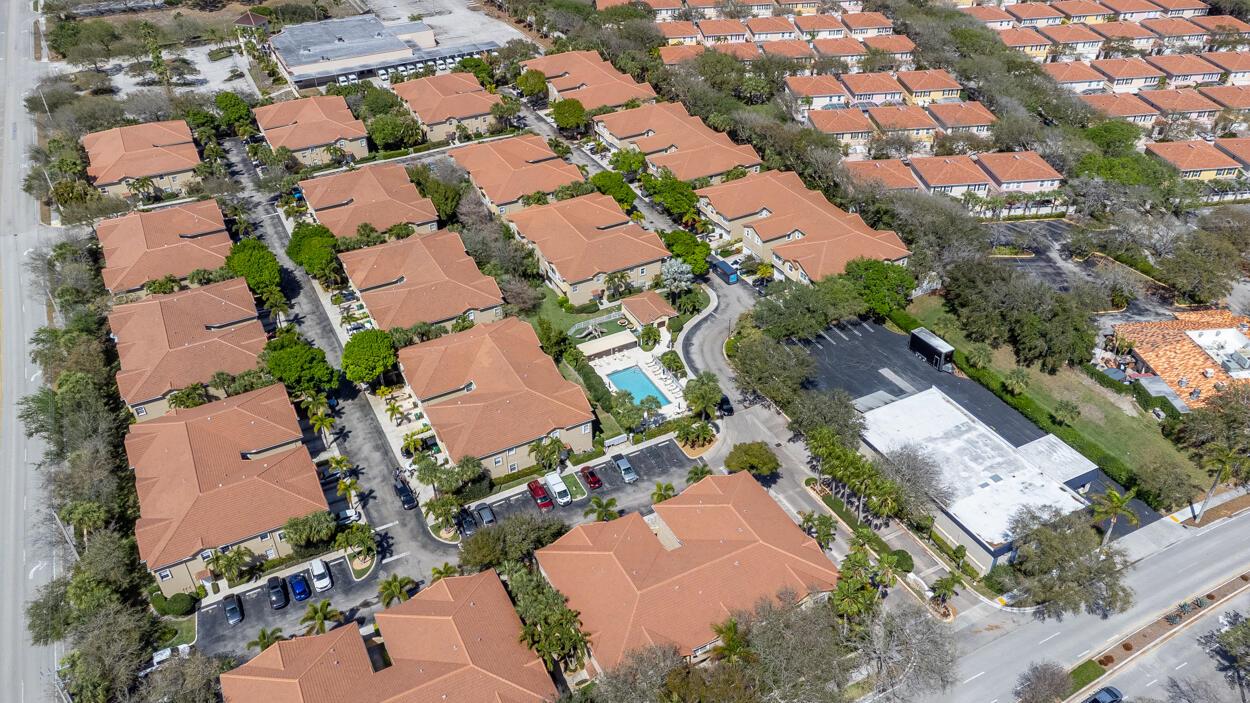 An aerial view shows a residential complex with multiple buildings, a pool, and parking areas — 110 Lighthouse Circle # H, Tequesta FL 33469, TEQUESTA, FL