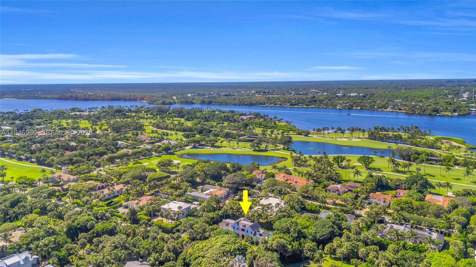 An aerial view shows a residential house surrounded by lush trees near a golf course — 44 S Beach Rd, Hobe Sound FL 33455, HOBE SOUND, FL