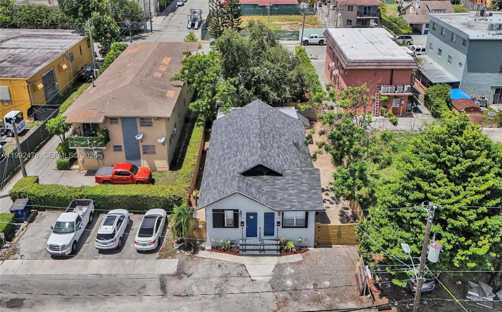 An aerial view shows a single-story house with a gray roof and two blue doors — 2135 SW 4th St, Miami FL 33135, MIAMI, FL