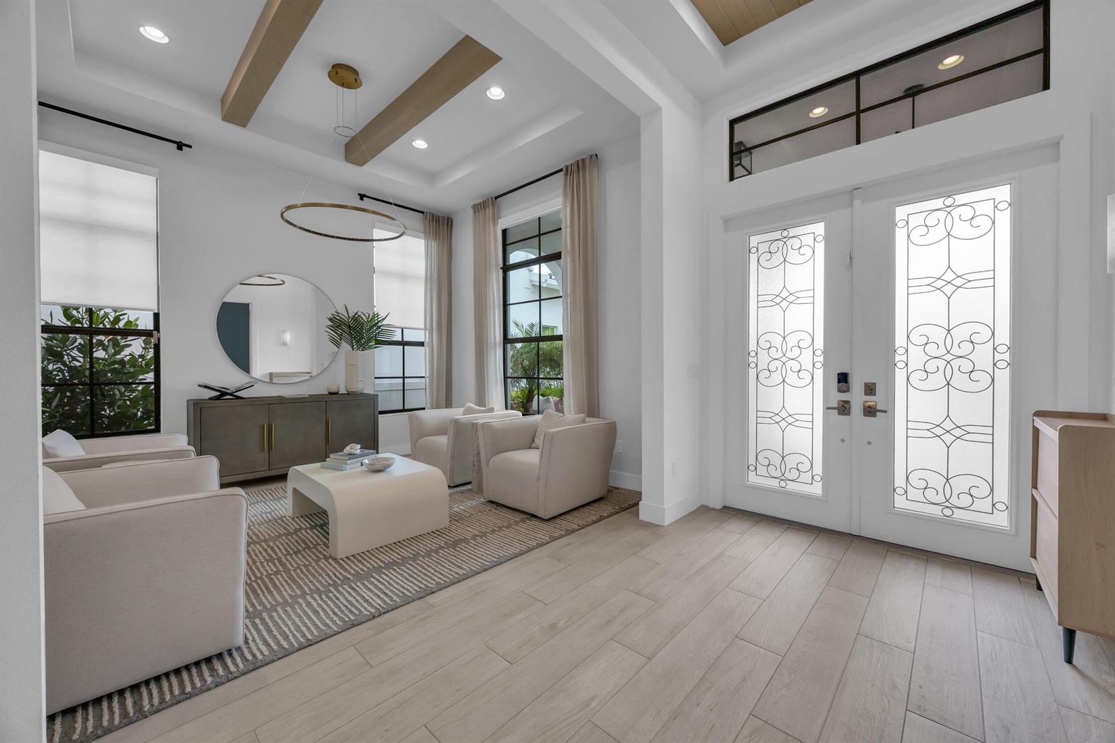 A bright foyer features light wood floors, coffered ceilings with beams, and a seating area — 13372 Bernoulli Way, Palm Beach Gardens FL 33418, PALM BEACH GARDENS, FL