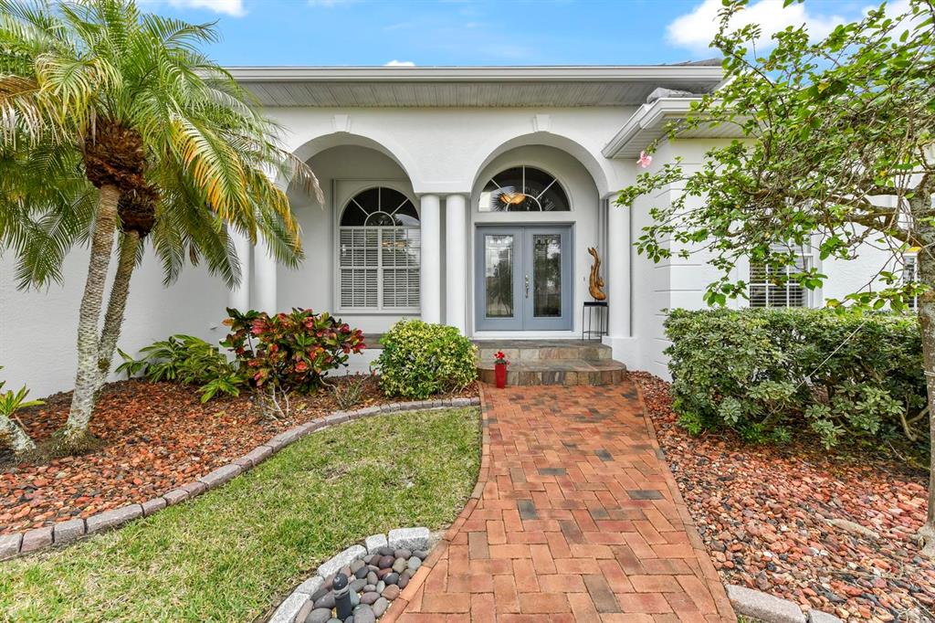 A brick walkway leads to the arched entryway and double front doors of a house — 3267 SUGARLOAF KEY ROAD, PUNTA GORDA, FL