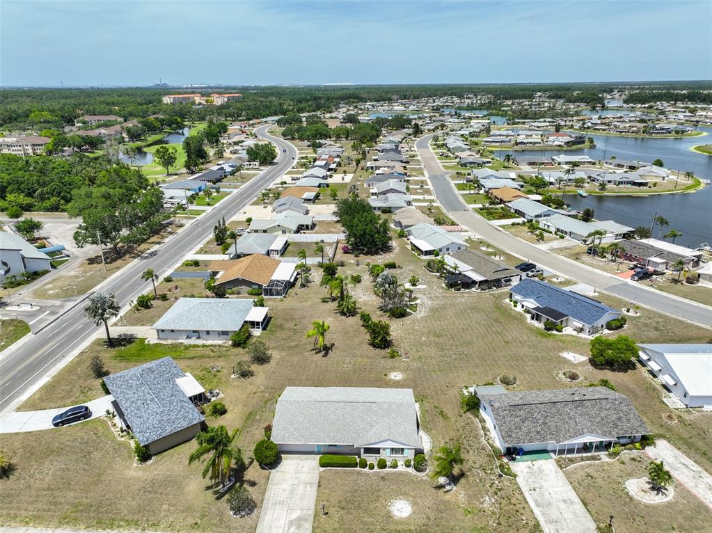 An aerial view shows a single-story house with a gray roof and driveway — 1809 HAVERFORD AVENUE, SUN CITY CENTER, FL