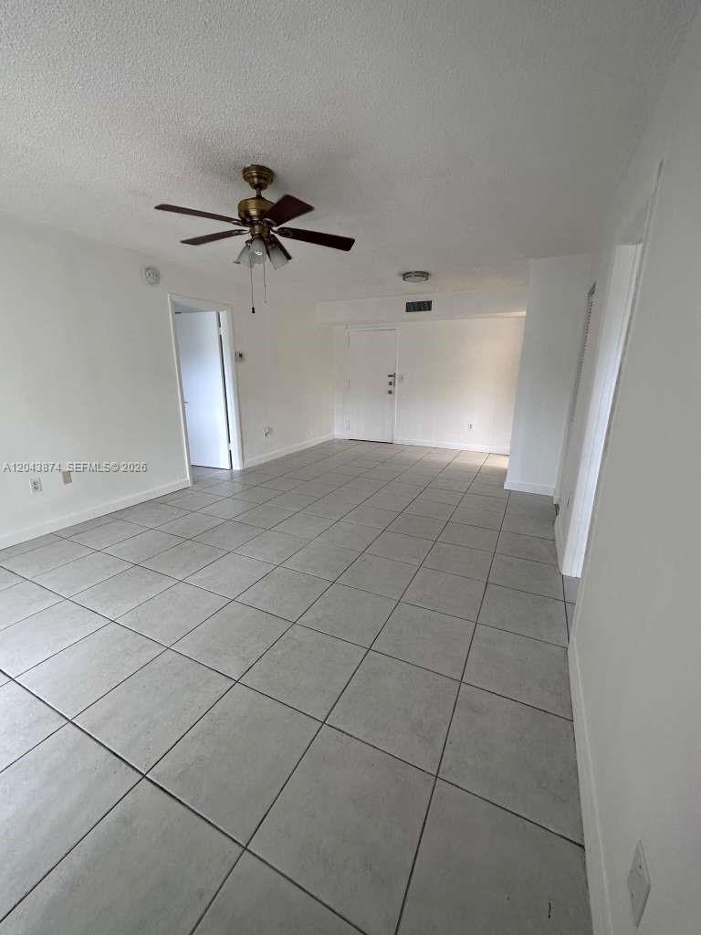 An empty room features white walls, a ceiling fan, and light-colored tile flooring — 4805 NW 7th St # 15, Miami FL 33126, MIAMI, FL