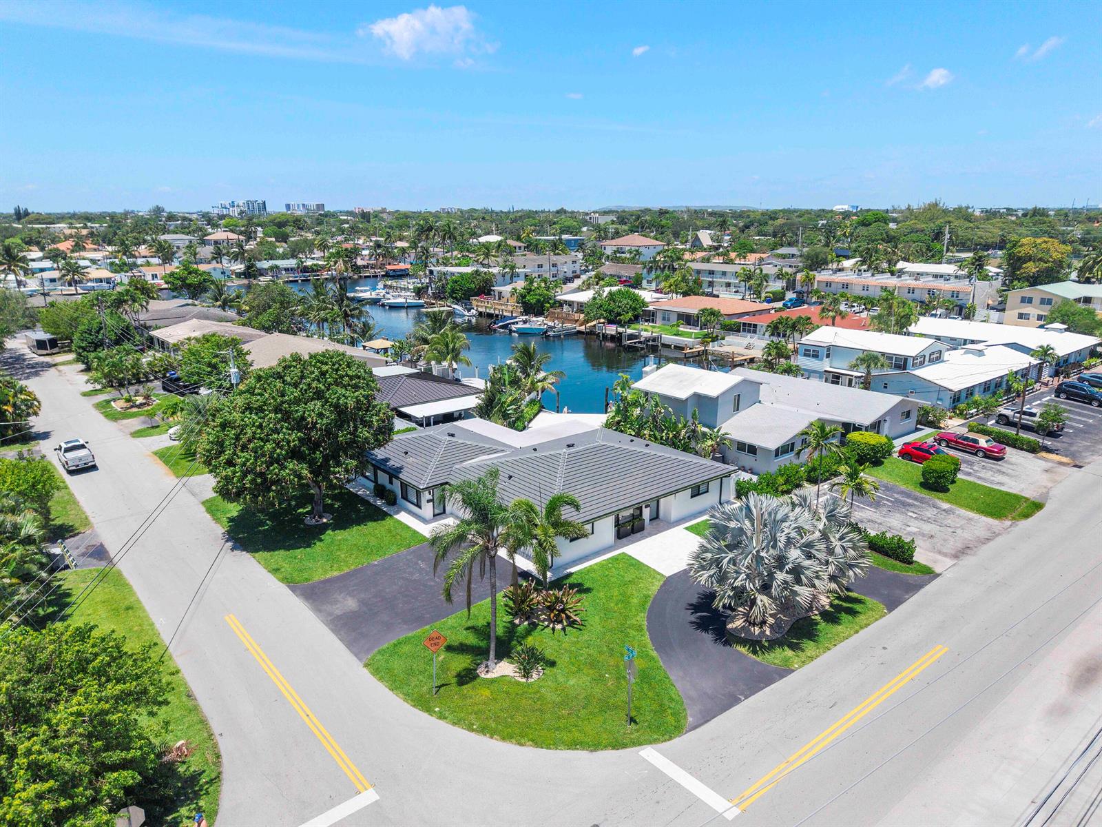 An aerial view of a white single-story house with a dark roof and two driveways — 491 SE 19th Avenue, Pompano Beach FL 33060, POMPANO BEACH, FL