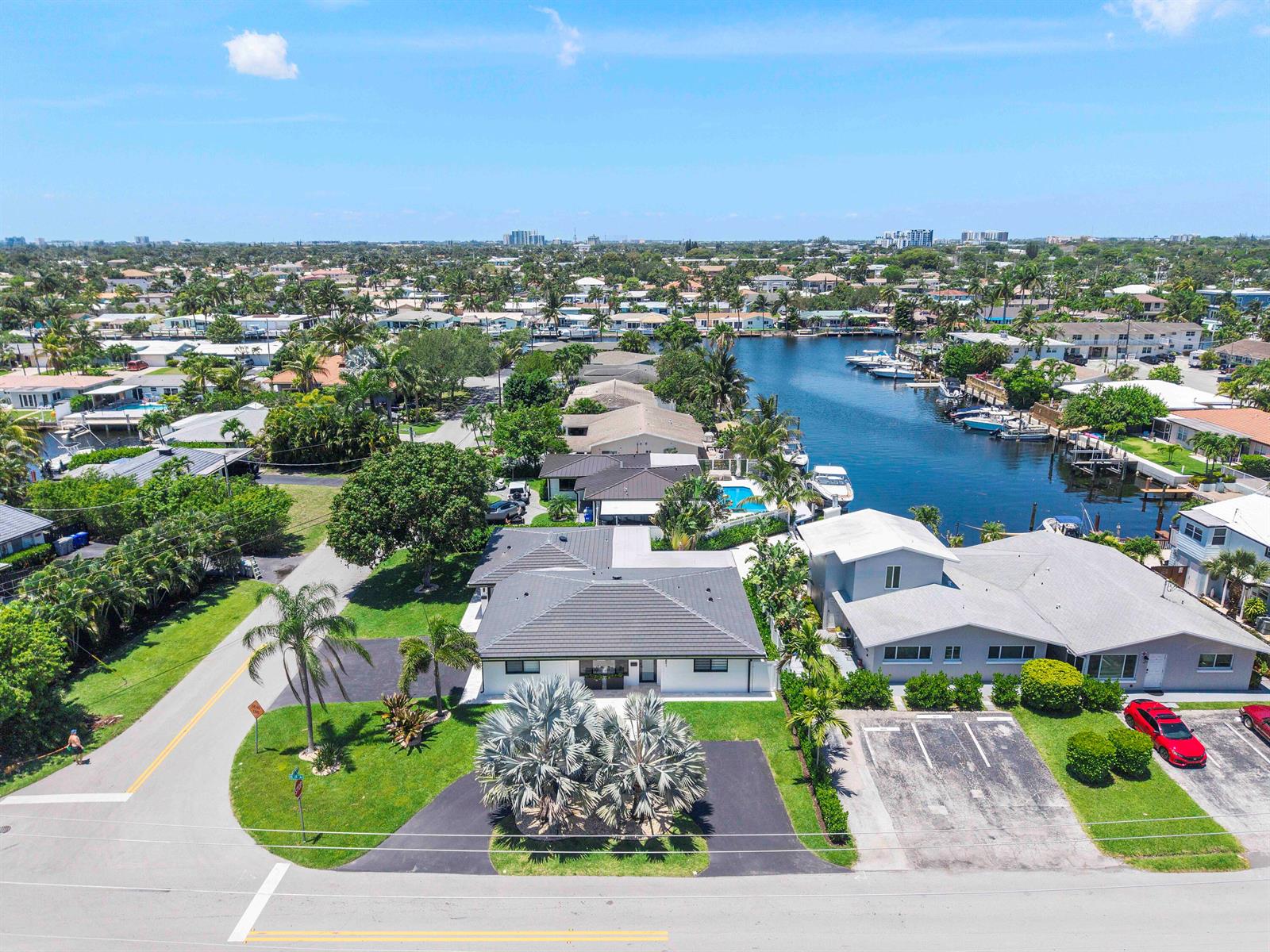 An aerial view shows a residential neighborhood with a canal, boats, and houses — 491 SE 19th Avenue, Pompano Beach FL 33060, POMPANO BEACH, FL