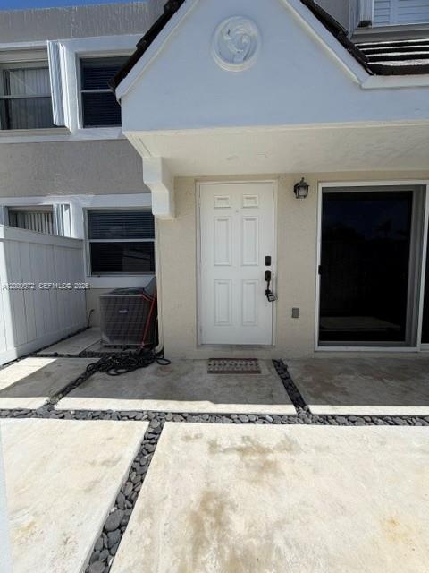 The exterior view shows a white front door, a window, and a concrete patio area — 4590 SW 68th Ct Cir # 8, Miami FL 33155, MIAMI, FL
