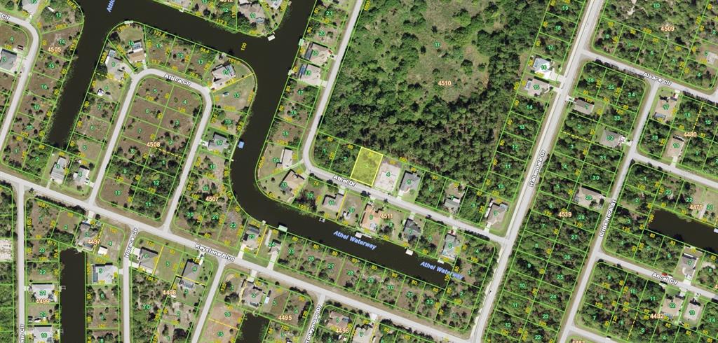 This is an aerial map showing a vacant residential lot highlighted in yellow on a street — 9478 ATHEL DRIVE, PORT CHARLOTTE, FL