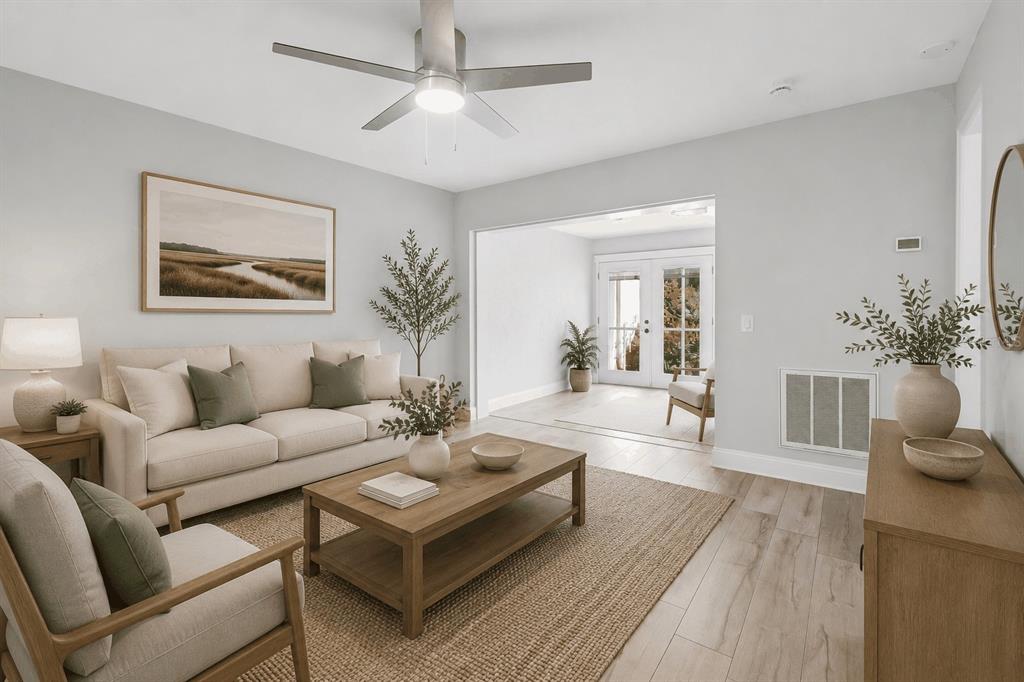 A living room with a beige sofa, wooden coffee table, and ceiling fan — 3157 LANDMARK DRIVE UNIT 414, CLEARWATER, FL