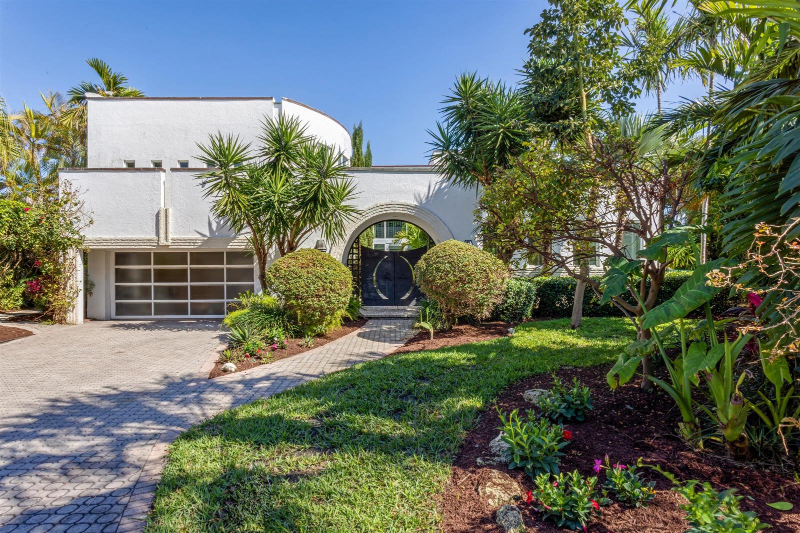 A white two-story house with a curved wall, a garage, and a gated arched entryway — 794 Staghorn Court, Boca Raton FL 33432, BOCA RATON, FL