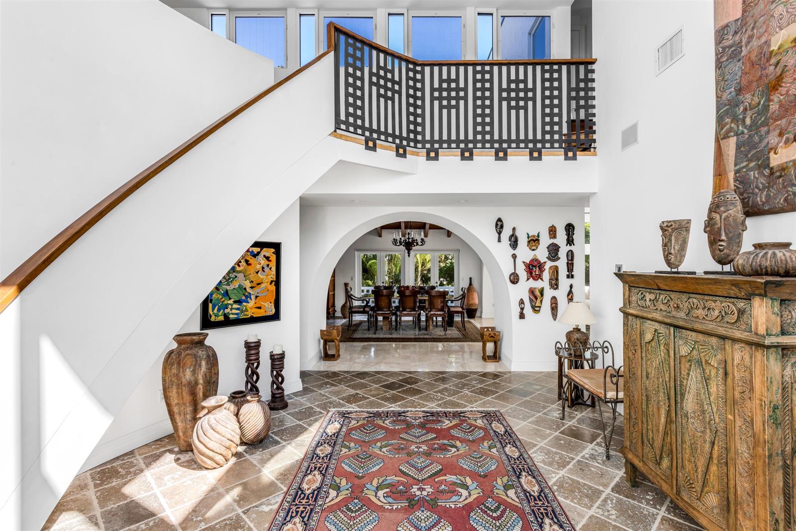 A tiled foyer features a staircase, an arched entryway to a dining room, and decor — 794 Staghorn Court, Boca Raton FL 33432, BOCA RATON, FL