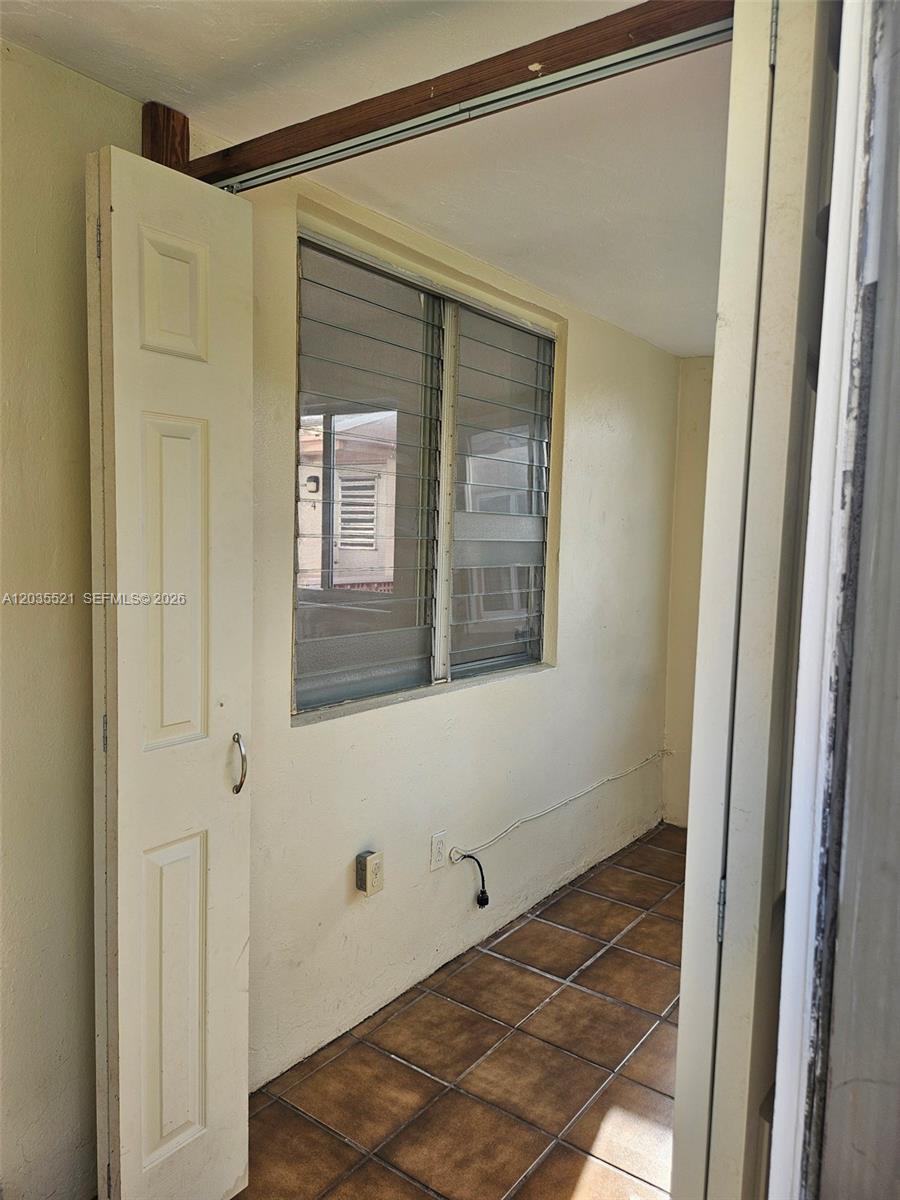 A small room features tiled flooring, a louvered window, and a partially open door — 709 NE 4th Ct # 6, Hallandale Beach FL 33009, HALLANDALE BEACH, FL
