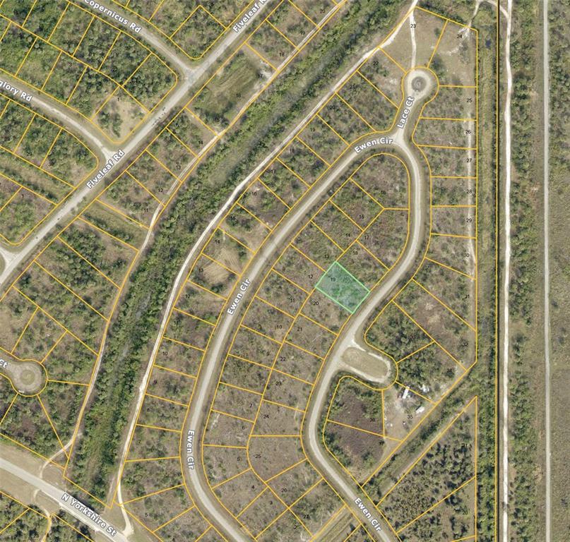 An aerial map view shows a vacant residential lot highlighted in green within a neighborhood — LOT 19 EWEN CIRCLE, NORTH PORT, FL