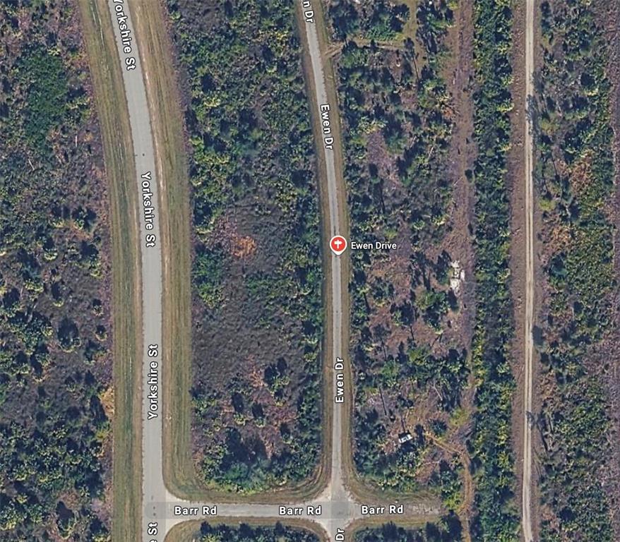 This is an aerial map view showing two paved roads intersecting with undeveloped wooded land — LOT 19 EWEN CIRCLE, NORTH PORT, FL