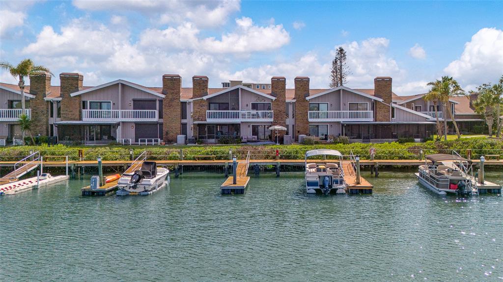 An exterior view of waterfront townhomes with private boat docks and slips — 121 LAGOON COURT, NEW SMYRNA BEACH, FL