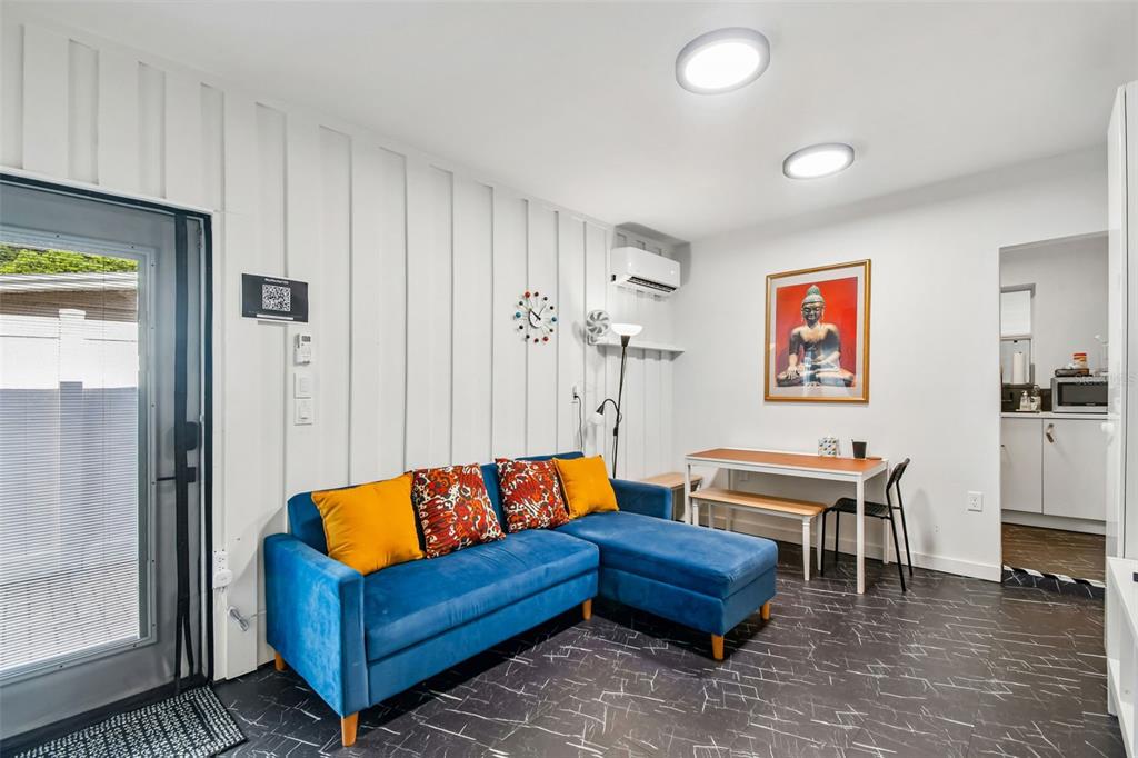 A living room features a blue sectional sofa, a dining table, and dark tiled floors — 2013 LOCH BERRY ROAD, WINTER PARK, FL