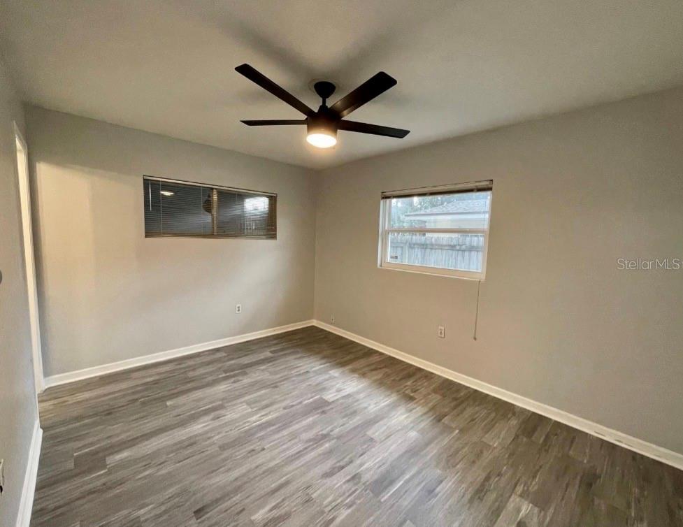 An empty bedroom features light gray walls, wood-look flooring, and a ceiling fan — 1751 WESTCHESTER AVENUE, WINTER PARK, FL