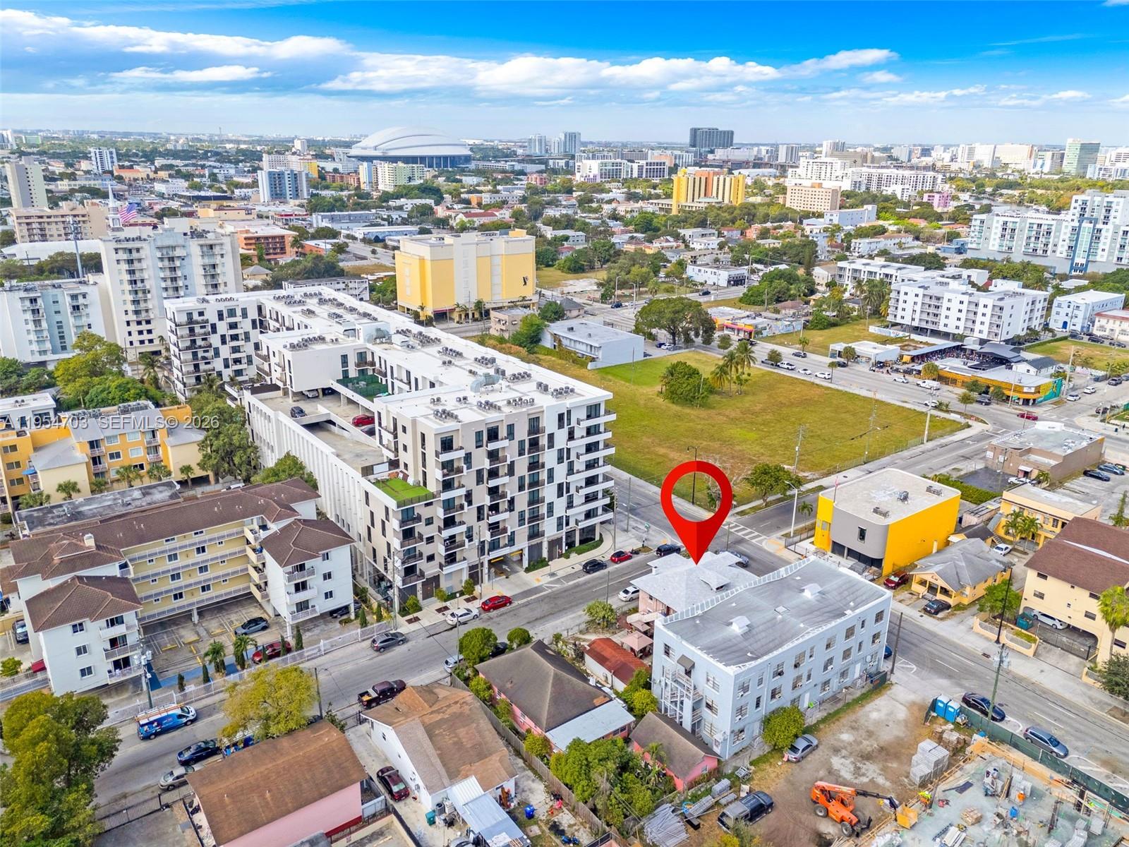 An aerial view shows a multi-story apartment building marked with a red location pin — 676 SW 1st St, Miami FL 33130, MIAMI, FL