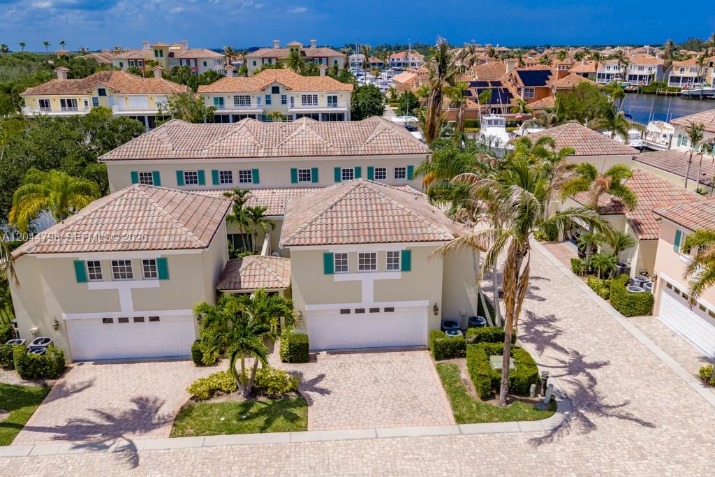 An aerial view of a two-story suburban house with a tiled roof and driveway — VERO BEACH, FL