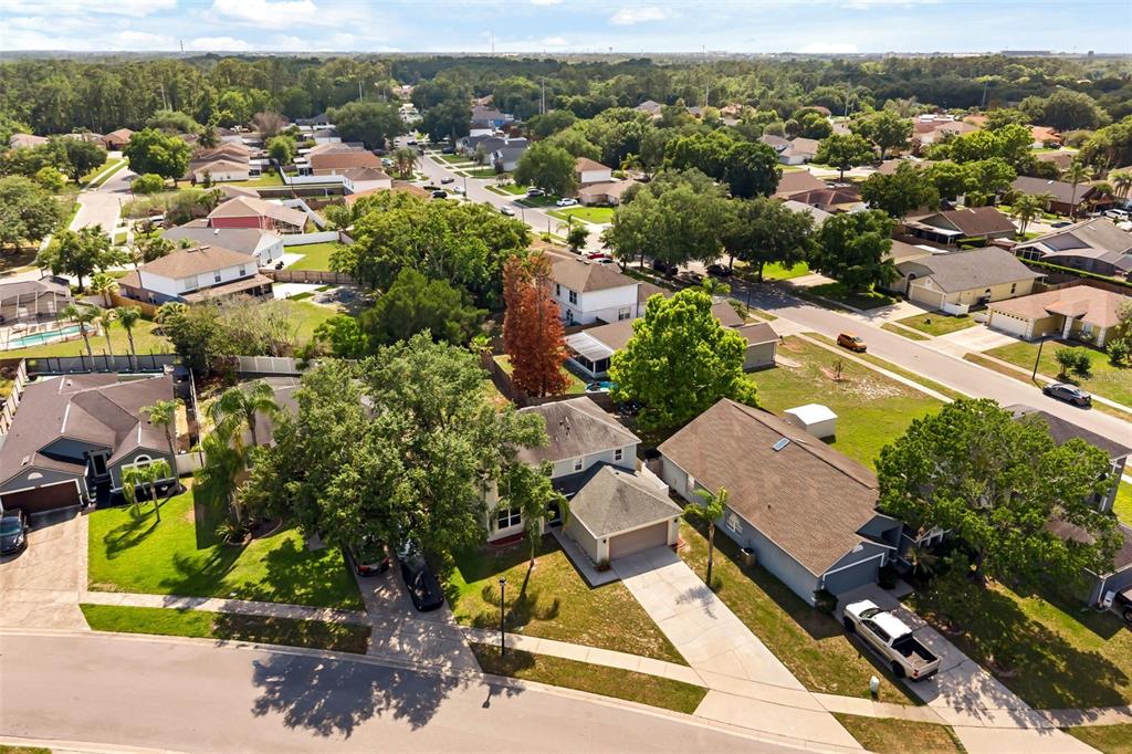 An aerial view of a suburban neighborhood featuring single-family homes with driveways and mature trees — 4232 STONEFIELD DRIVE, ORLANDO, FL