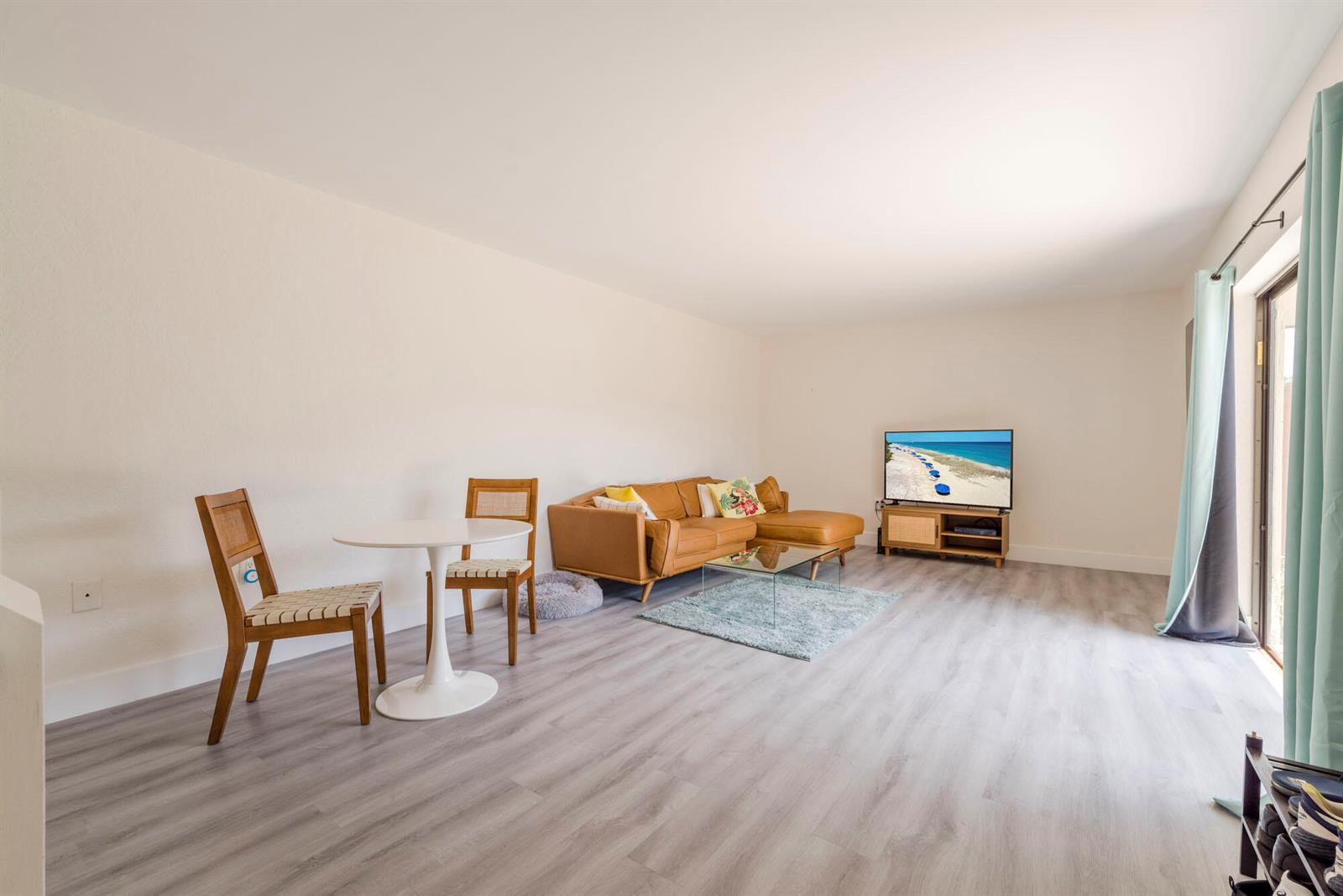 A living room features light wood-look flooring, a tan sectional sofa, and a small dining set — 3900 County Line Road # 21a, Tequesta FL 33469, TEQUESTA, FL