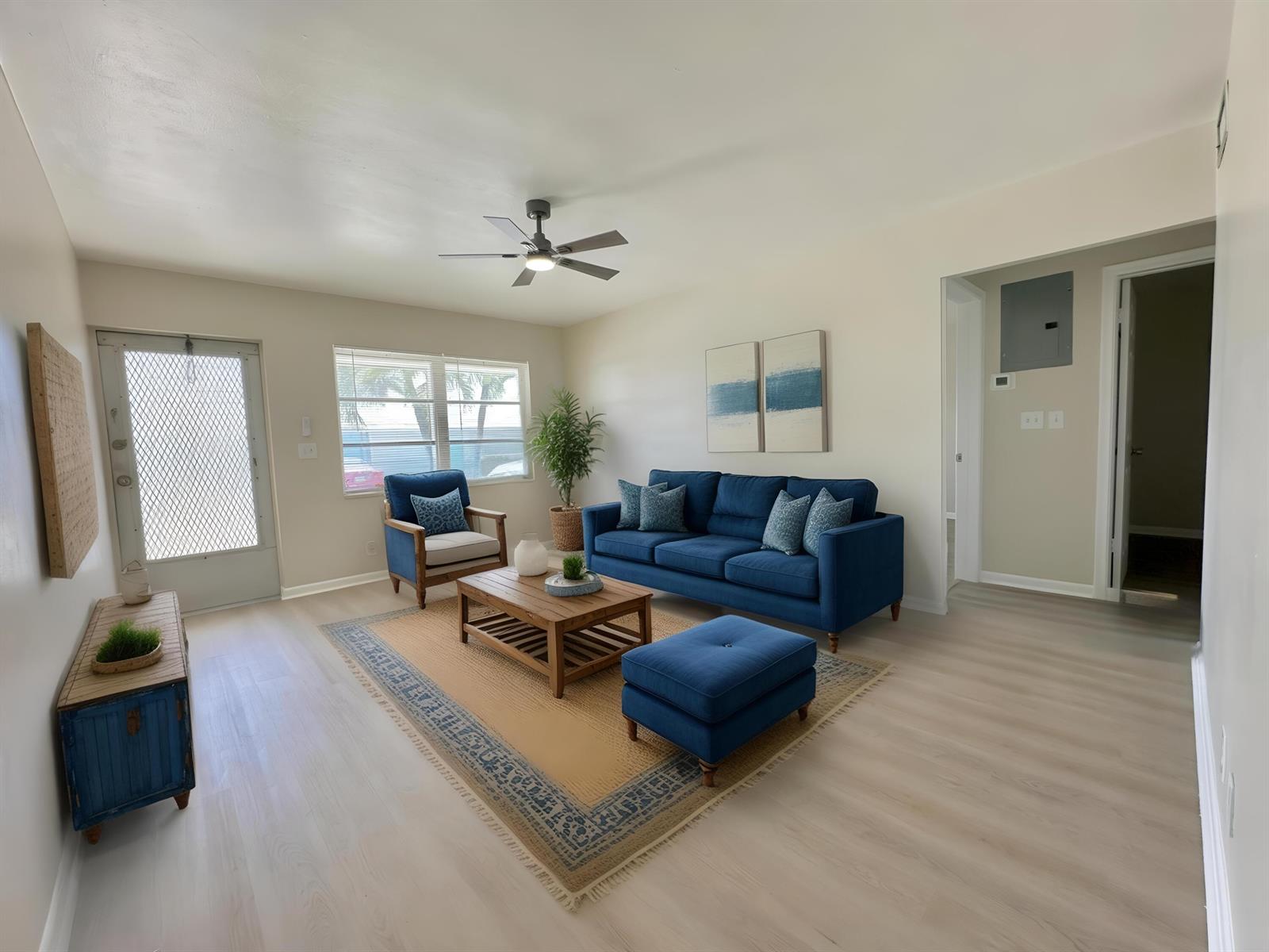A living room features a blue sofa, matching ottoman, wood coffee table, and light flooring — 728 Ridge Road # 31, Lantana FL 33462, LANTANA, FL
