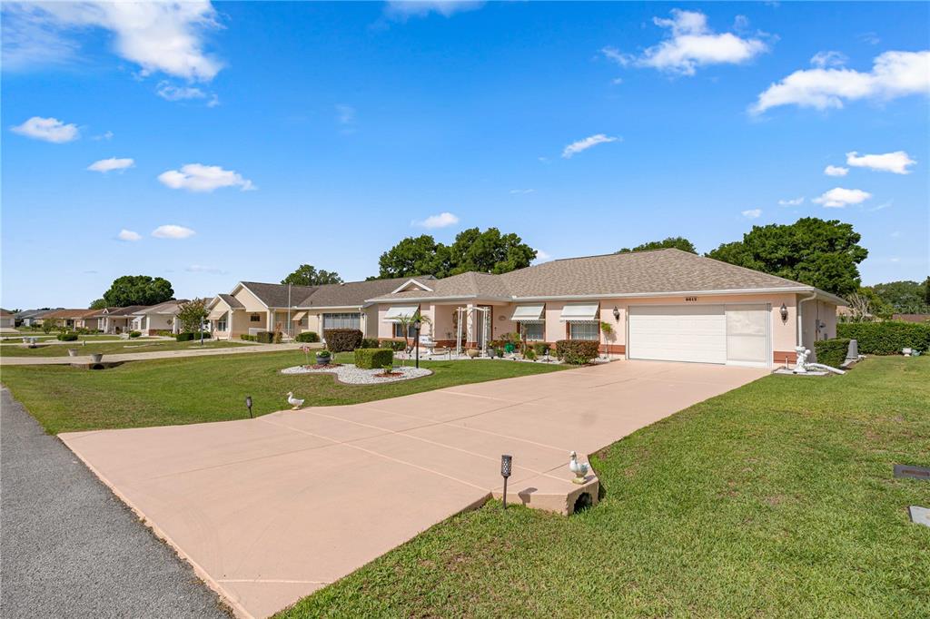 A single-story house with a beige exterior, a two-car garage, and a concrete driveway — 8612 SW 61ST COURT, OCALA, FL