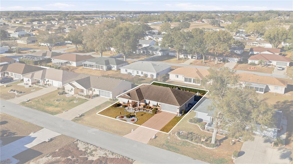 An aerial view shows a single-story house with a brown roof and a paved driveway — 8612 SW 61ST COURT, OCALA, FL
