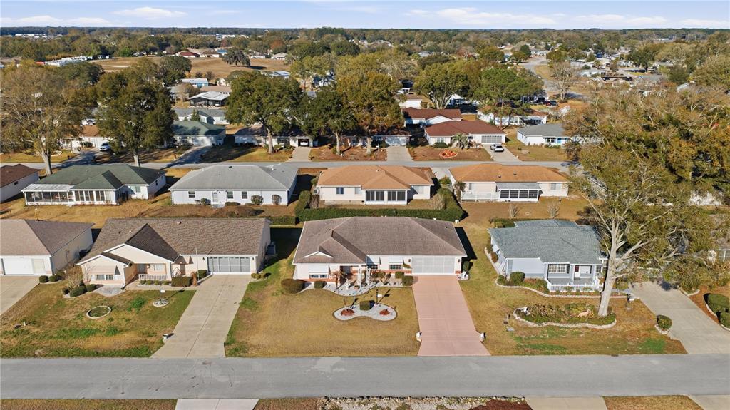 An aerial view shows a suburban neighborhood with single-story houses, driveways, and mature trees — 8612 SW 61ST COURT, OCALA, FL