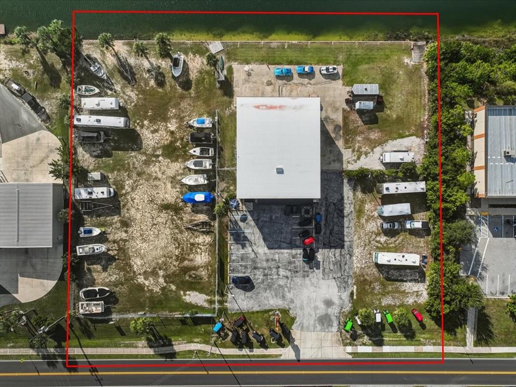 Aerial view of a commercial property with a central building, parking, and outdoor storage — 4001 SHOAL LINE BOULEVARD, HERNANDO BEACH, FL