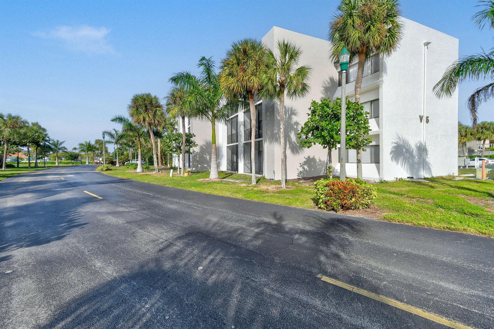 A multi-story white building with palm trees and a paved road in the foreground — 1605 S Us Highway 1, Jupiter FL 33477, JUPITER, FL