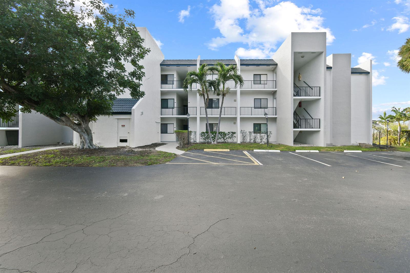 A three-story white apartment building features a parking lot and palm trees in front — 1605 S Us Highway 1, Jupiter FL 33477, JUPITER, FL