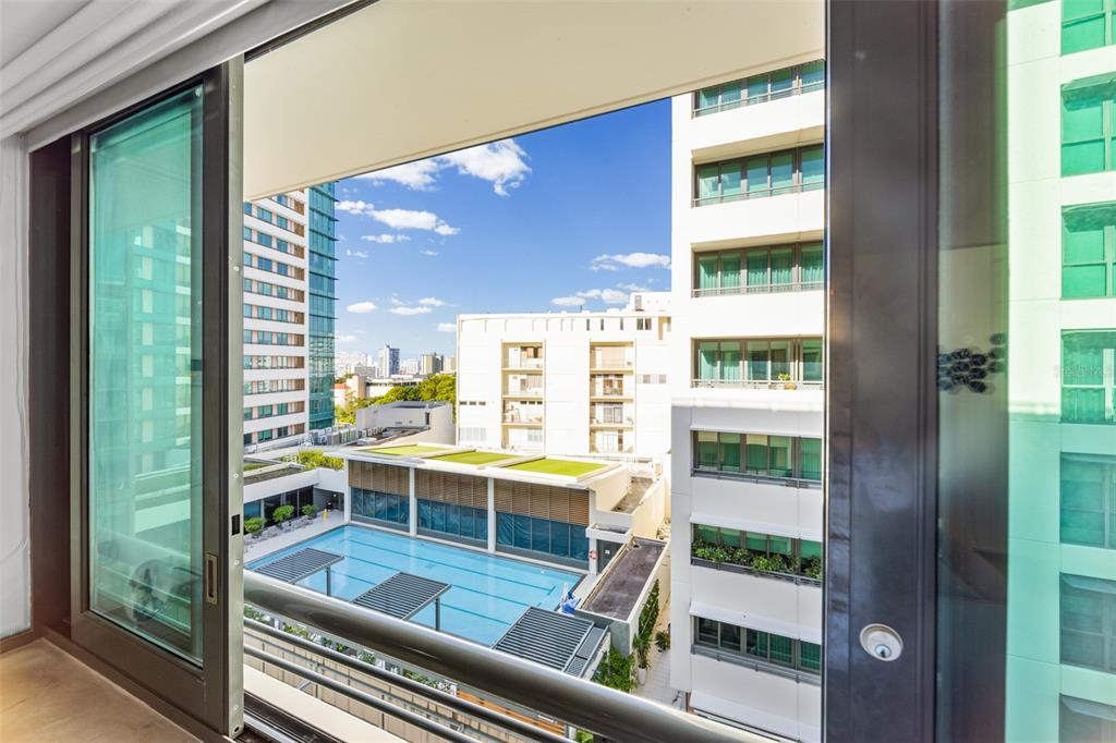 A view from a balcony overlooking a swimming pool surrounded by modern apartment buildings — 1511 AVENIDA JUAN PONCE DE LEÓN CIUDADELA TORRE 800 UNIT 861, SAN JUAN, PR