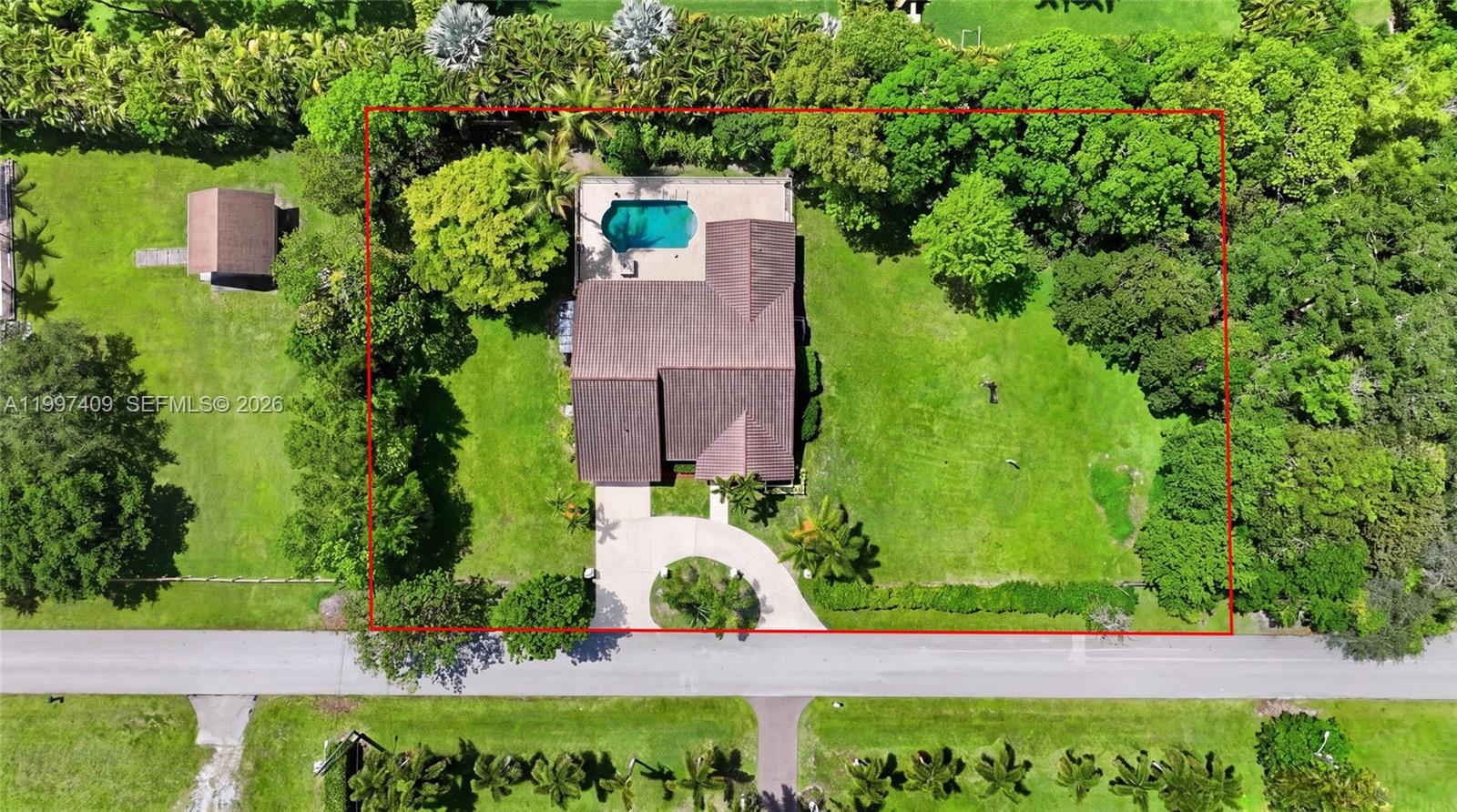 An aerial view shows a house with a pool and circular driveway on a lot — 11400 NW 20th Ct, Plantation FL 33323, PLANTATION, FL