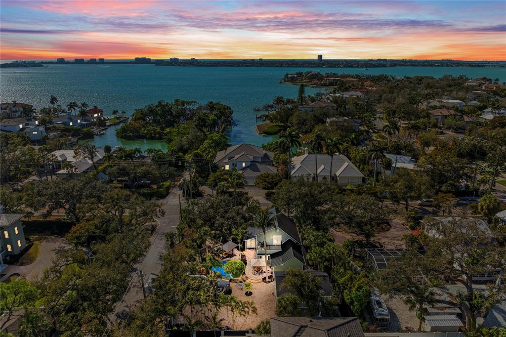 An aerial view shows a coastal residential neighborhood with a house featuring a private pool — 1611 HYDE PARK STREET, SARASOTA, FL