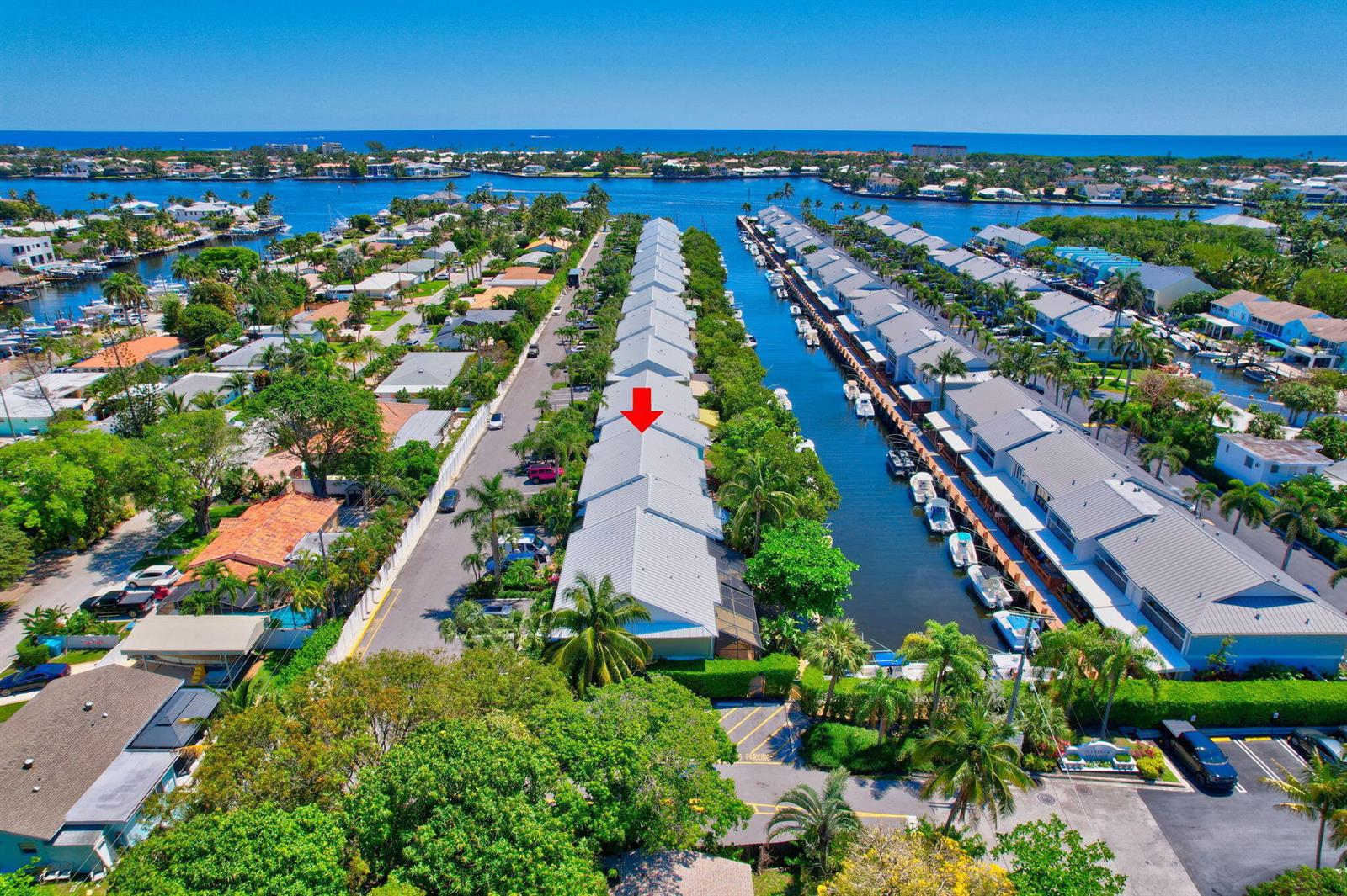 An aerial view of a waterfront townhouse complex with a red arrow pointing to one unit — 626 Mariners Way, Boynton Beach FL 33435, BOYNTON BEACH, FL