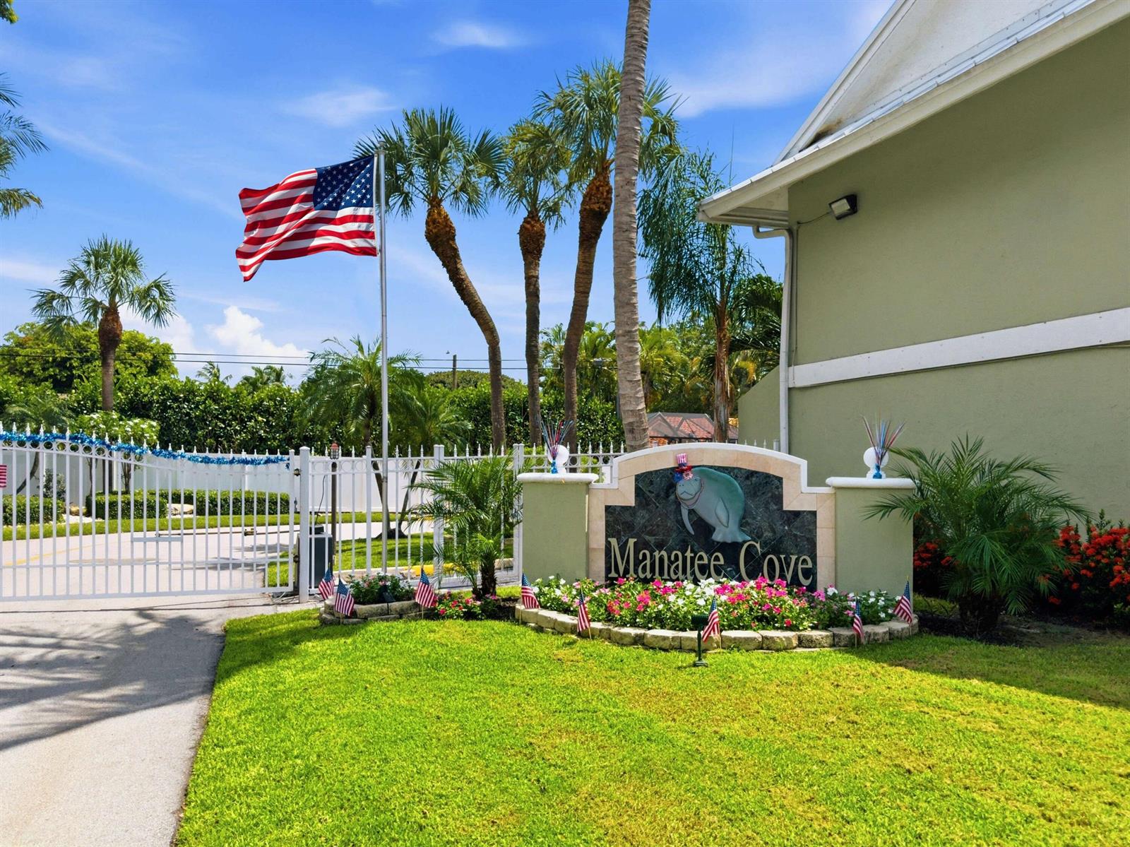 The entrance sign for Manatee Cove features a manatee graphic and an American flag — 626 Mariners Way, Boynton Beach FL 33435, BOYNTON BEACH, FL